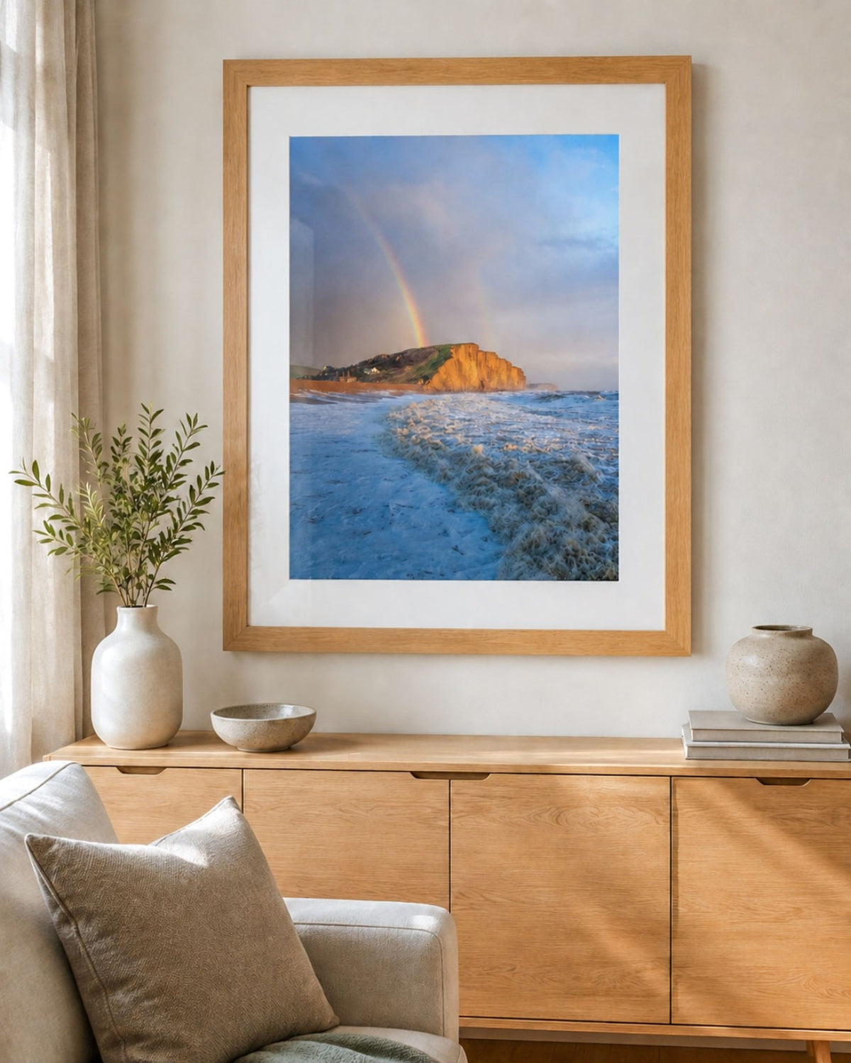 East Cliff Gold West Bay rainbow photograph in a chunky oak frame with white mount in a contemporary living room