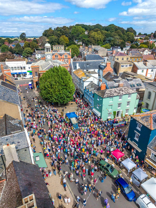 Aerial photograph of Bridport Hat Festival 2026 crowds and festival sign outside Bridport Arts Centre in Dorset