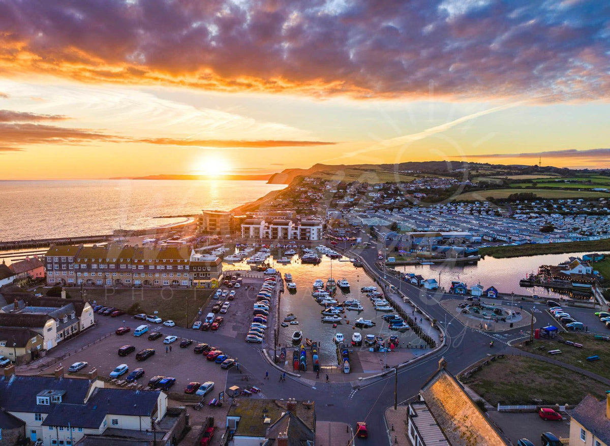 Harbour Glow - sunset over West Bay harbour and West Cliff, Dorset