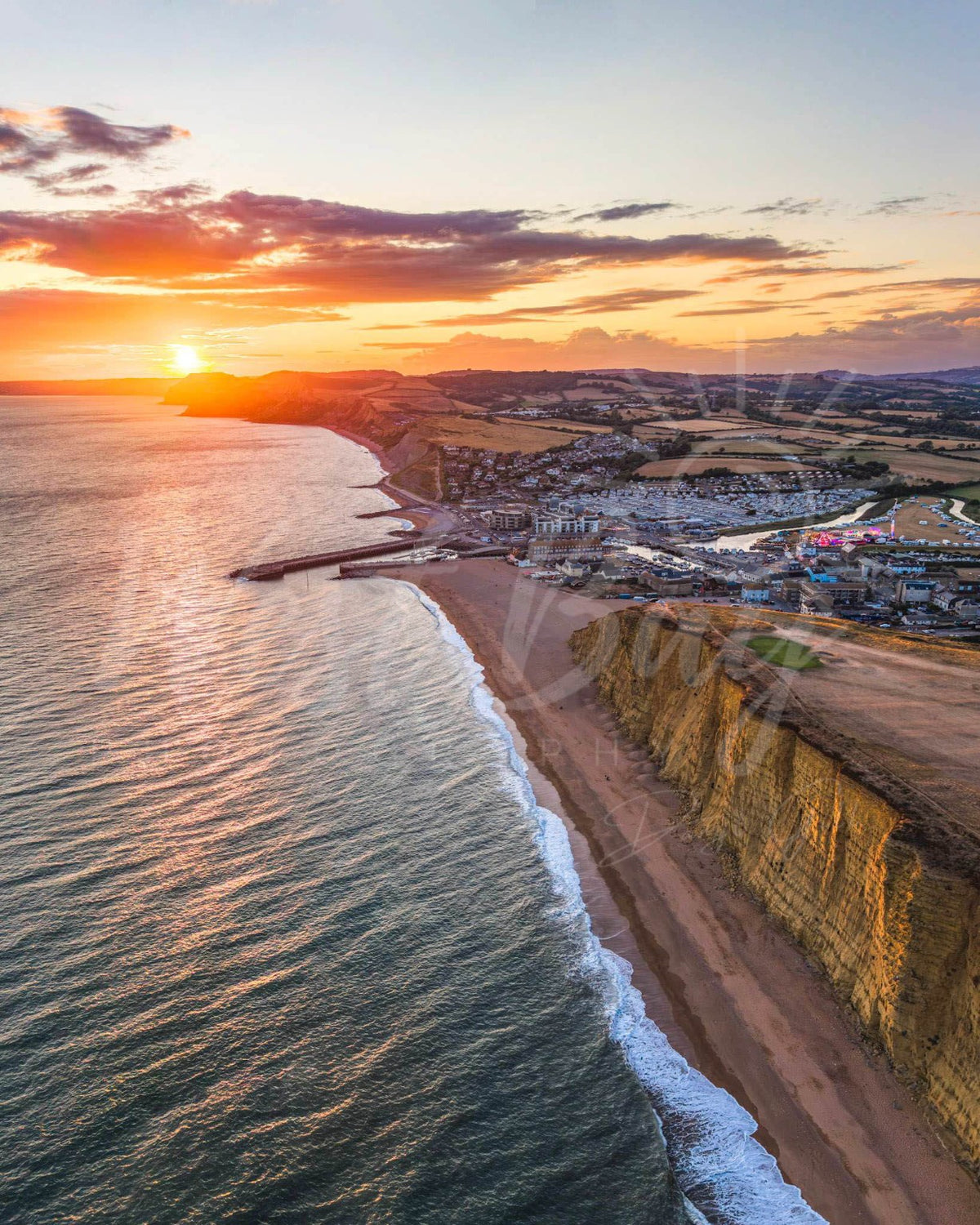 Jurassic Glow - sunset aerial photograph over West Bay and the Jurassic Coast, Dorset