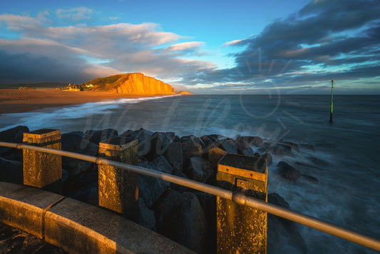Evening golden light illuminating East Cliff at West Bay, Dorset